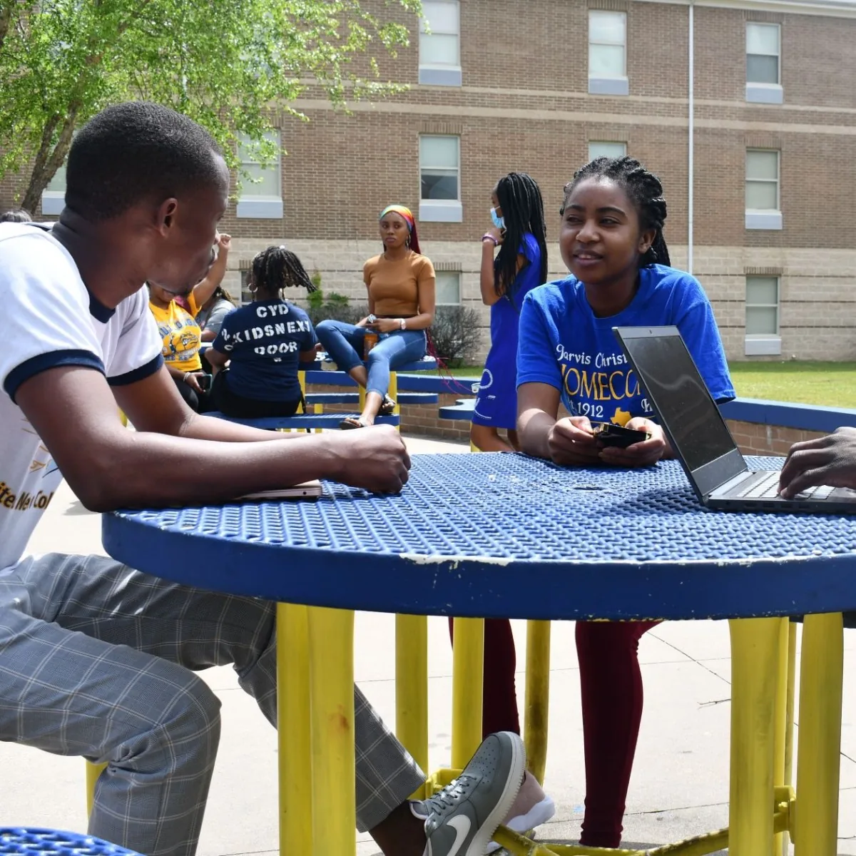 Jarvis students in blue and gold university gear gathering outside the Student Center